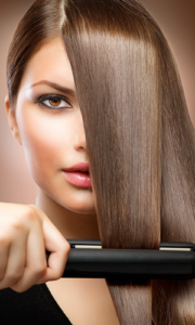 a woman using a hair straightener